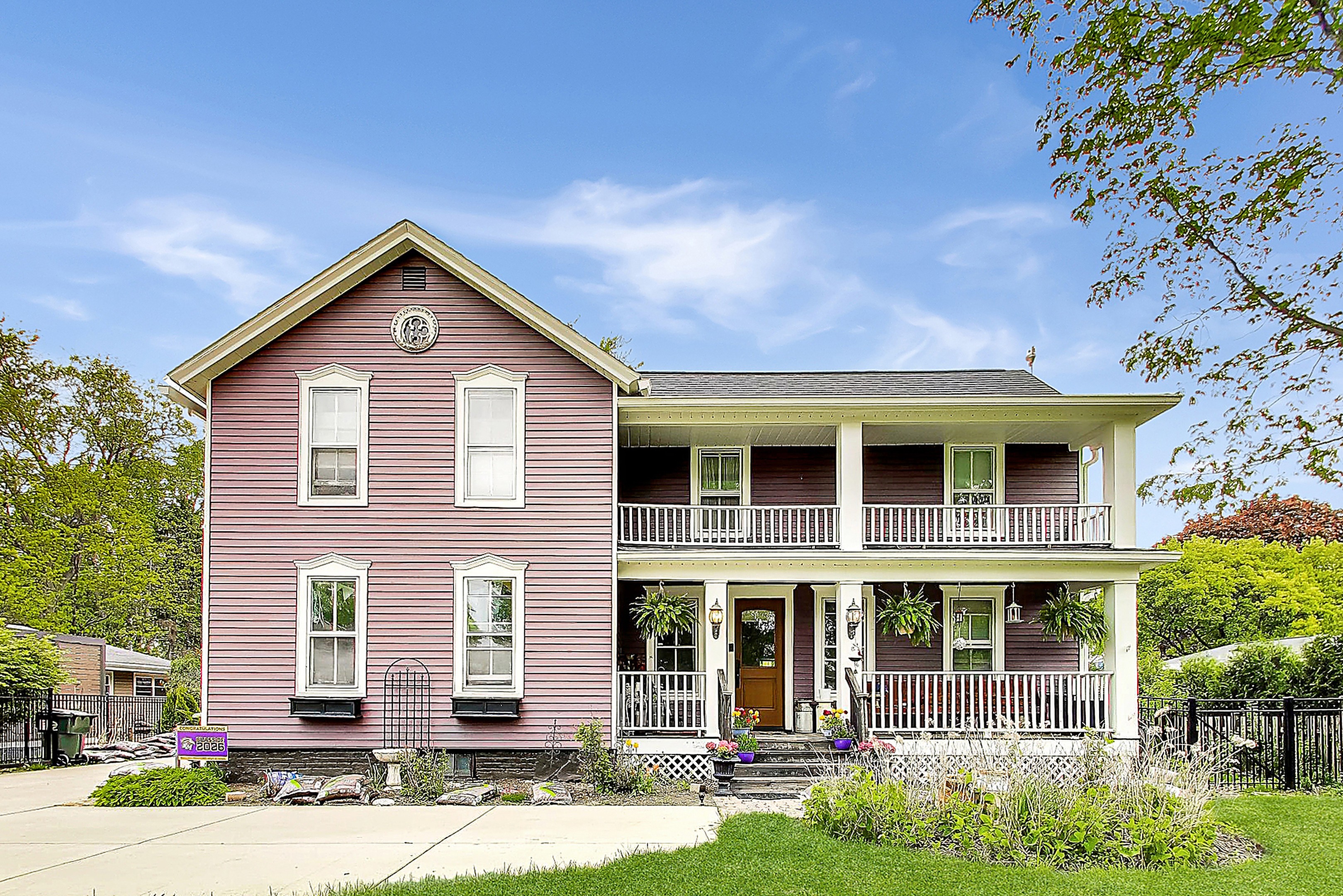 Two-story farmhouse with a covered porch at 310 West Kirchhoff Road, Arlington Heights
